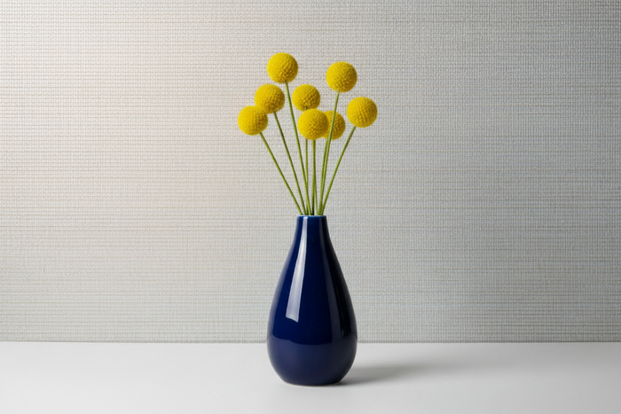 Navy vase with lustrous silver wallpaper