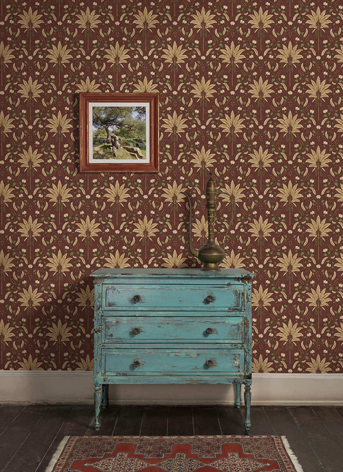 Ariara wallpaper in Maroon hung on a feature wall