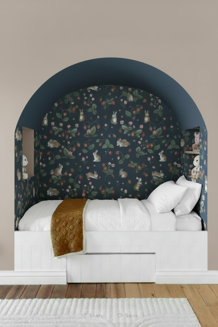 Bedroom nook with navy wallpaper, white bedding, mustard throw, and complementary walls