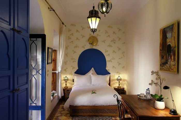 Fantail Flight Wallpaper Moroccan Room with Blue Bedhead