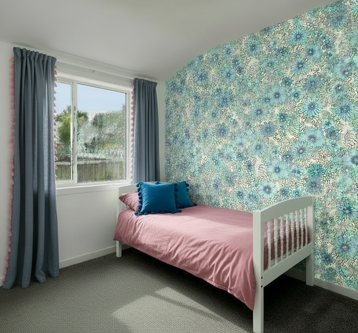 Children's bedroom with dusky pink duvet and blue tassel cushions