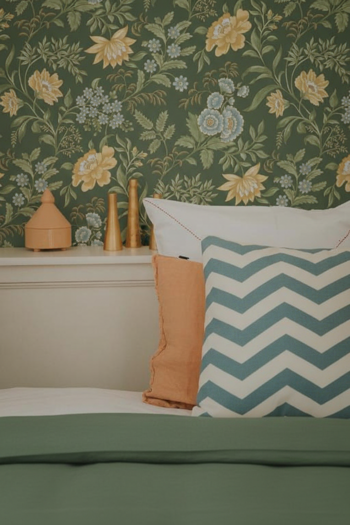 Bedroom with forest green duvet and wallpaper