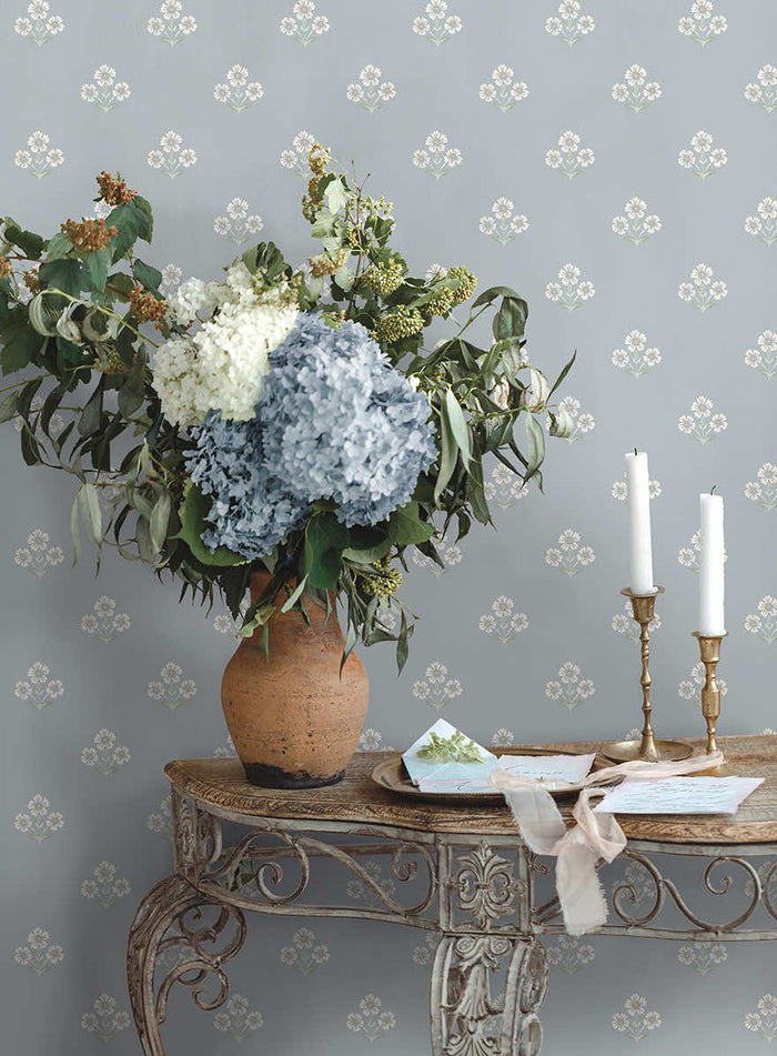 Blue Isadora floral sprig wallpaper on a country bedroom wall