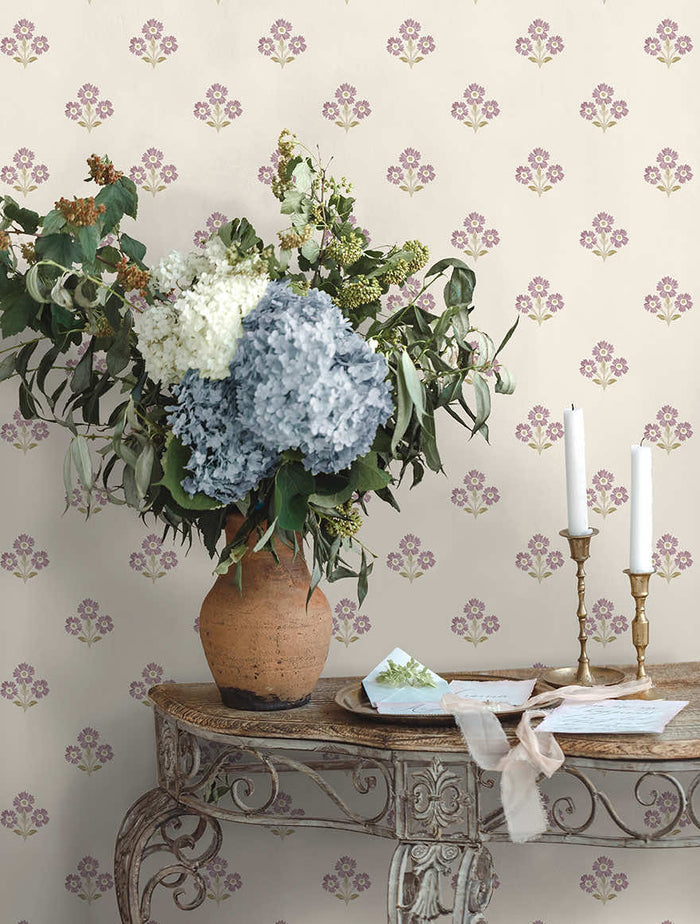 Neutral and mulberry Isadora floral sprig wallpaper on a bedroom wall