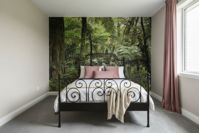 Bedroom with black wrought iron bed and NZ Forest mural