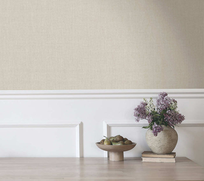 Cream Ormsby linen texture wallpaper on a bedroom wall