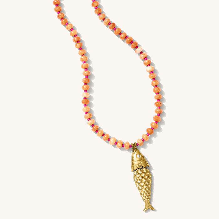 Pez necklace with papaya-colored carnelian beads and an articulated gold fish charm