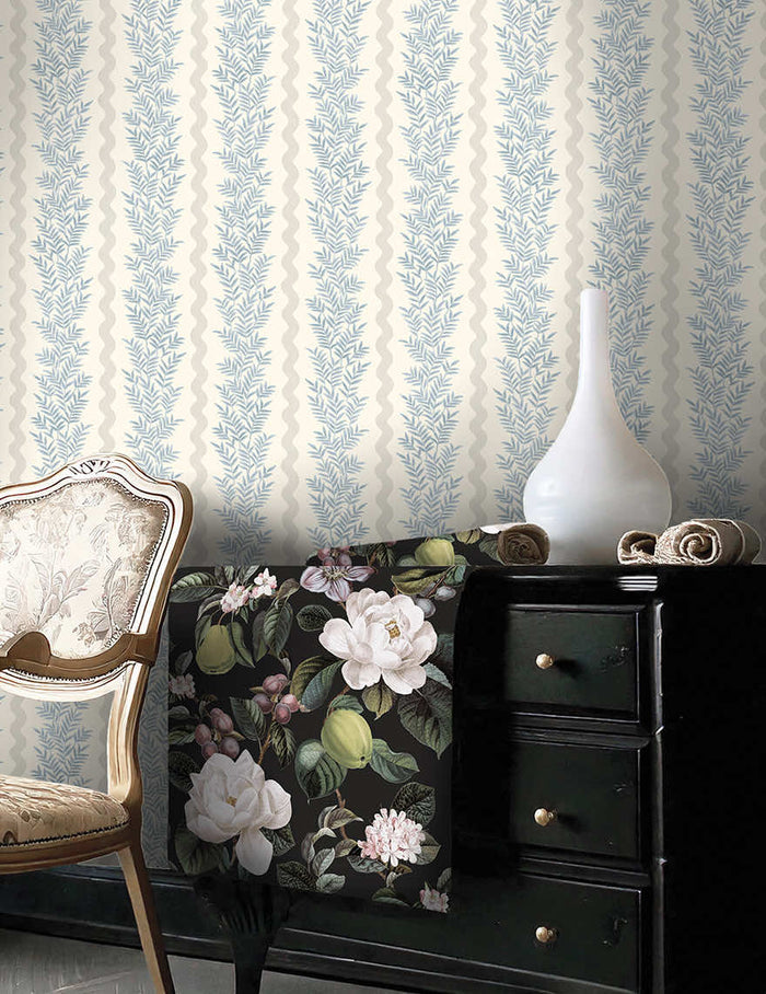 Neutral blue Pipkin leaf stripe wallpaper on a bedroom wall