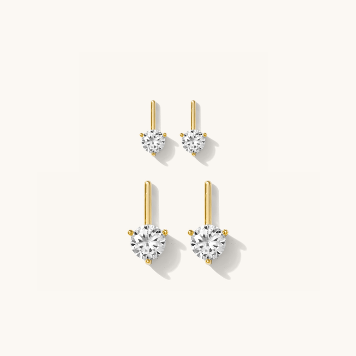 Round Diamond Bar earrings with a white topaz stone above a gold bar accent